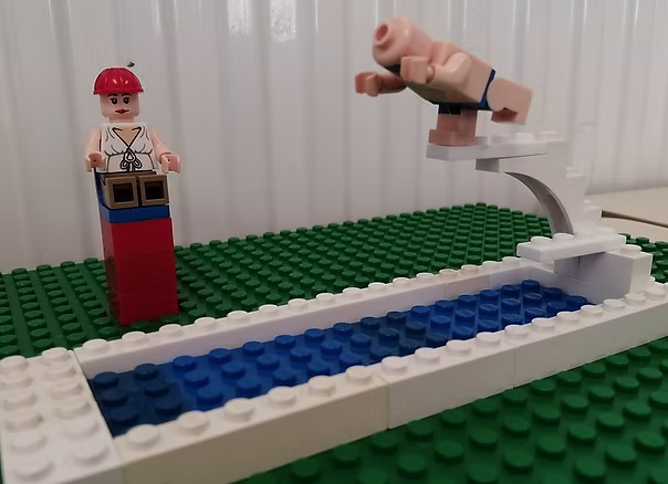 Lego figure diving into a pool